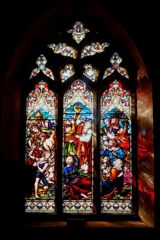 DC 24-0736-030.jpg :: Tenterden, Kent: St. Mildred's Church is an Anglican church located in Tenterden in the borough of Ashford in Kent. The church dates from about the 12th century and is Grade I heritage listed. The main tower of the church is 39.6 metres (130 feet) high and was constructed in 1461. It is dedicated to a prominent Anglo-Saxon saint, Saint Mildred, a 7th-century princess who served as the abbess of the nunnery at Minister-in-Thanet. The main tower of the church is built from Bethersden Marble, a limestone that contains thousands of brightly coloured shells. A graveyard is also present on the left-hand side of the church. Stained glass window. Moses made a serpent of brass, and put it upon a pole, and it came to pass, that if a serpent had bitten any man, when he beheld the serpent of brass, lived. - Ward & Hughes 1865. Photo taken 04/09/2024