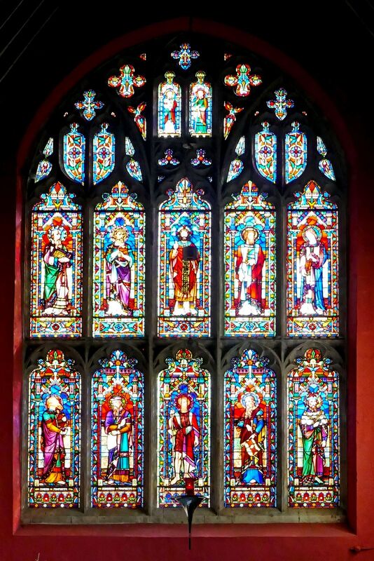 DC 24-0736-032.jpg :: Tenterden, Kent: St. Mildred's Church is an Anglican church located in Tenterden in the borough of Ashford in Kent. The church dates from about the 12th century and is Grade I heritage listed. The main tower of the church is 39.6 metres (130 feet) high and was constructed in 1461. It is dedicated to a prominent Anglo-Saxon saint, Saint Mildred, a 7th-century princess who served as the abbess of the nunnery at Minister-in-Thanet. The main tower of the church is built from Bethersden Marble, a limestone that contains thousands of brightly coloured shells. A graveyard is also present on the left-hand side of the church. Stained glass window. Upper Lights- Matthew, Mark, Christ as Salvator Mund, Luke, John   Lower Lights- Isaiah, Jeremiah, John the Baptist, Ezekiel, Daniel. -  Lavers & Barraud 1864. Photo taken 04/09/2024