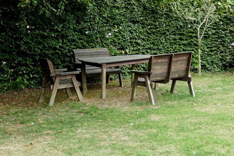 DC 24-0736-083.jpg :: Tenterden, Kent: Little Silver Country Hotel, a former 16-bedroom hotel and wedding venue on Ashford Road in Tenterden. The main part of the property features a mock-Tudor façade and dates back to the mid-20th century. Garden bench and table. Photo taken 04/09/2024