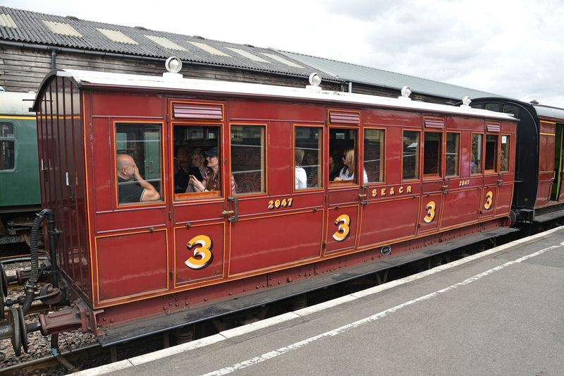 DC 24-0737-034.jpg :: Kent and East Sussex Railway: Tenterden Town Railway Station. Carriage 2947. This 40 seat, 2nd class vehicle was built by the SE&CR at Ashford in 1901 was a typical London suburban coach of the late Victorian era. In 1921 No. 2947 was withdrawn & the body sold for incorporation (with three other coach bodies) into a bungalow in Ashford, where it remained in use until 1986. This 40 seat, 2nd class vehicle was built by the SE&CR at Ashford in 1901 was a typical London suburban coach of the late Victorian era. In 1921 No. 2947 was withdrawn & the body sold for incorporation (with three other coach bodies) into a bungalow in Ashford, where it remained in use until 1986. The coach was well preserved and was acquired by the K&ESR for restoration, commencing in 1994. It entered service just one year and three days after restoration commenced. Photo taken 04-09-2024