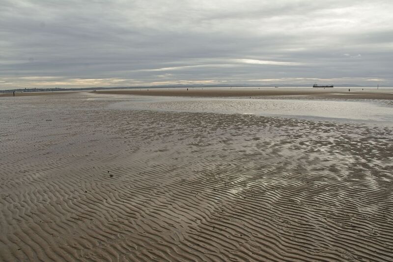 DC 24-0746-010.jpg :: Crosby Beach, Merseyside: Crosby Beach is part of the Merseyside coastline north of Liverpool in the Metropolitan Borough of Sefton, England, stretching about 2.5 miles (4.0 km) North-West from the Seaforth Dock in the Port of Liverpool, through Waterloo, where it separates the sea from the Marina. The beach was awarded Keep Britain Tidy's Quality Coast Award in 2011. Since 2007, the beach has been the permanent home of the Another Place sculptures by Antony Gormley. Photo taken 27/10/2024