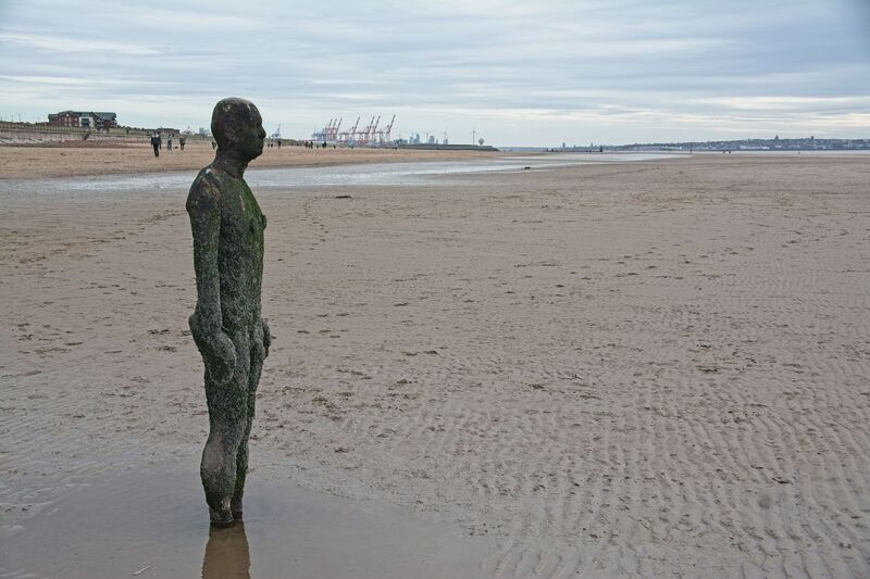 DC 24-0746-029.jpg :: Crosby Beech, Merseyside: Commonly referred to as ‘The Iron Men’ (or even the Crosby Beach statues), the art installation is officially called ‘Another Place’. Another Place was created by world-famous artist and sculptor Sir Antony Gormley, who famously created The Angel of the North. The Iron Men consist of 100 cast iron figures that have been installed along Crosby Beach facing the sea. The figures themselves are modelled from Antony Gormley’s body, and they were cast in the UK in both Halifax and West Bromwich. The Iron Men arrived in Liverpool in July 2005, but their story begins nearly 10 years earlier. In 1997, Another Place was first installed on Cuxhaven beach, in Lower Saxony, Germany. From there, they went to Stavanger in Norway and then to De Panne in Belgium. When The Iron Men found their new home at Crosby Beach in 2005, it was only supposed to be temporary. Photo taken 27/10/2024