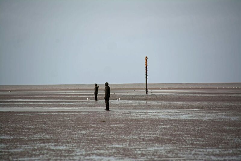 DC 24-0746-030.jpg :: Crosby Beech, Merseyside: Commonly referred to as ‘The Iron Men’ (or even the Crosby Beach statues), the art installation is officially called ‘Another Place’. Another Place was created by world-famous artist and sculptor Sir Antony Gormley, who famously created The Angel of the North. The Iron Men consist of 100 cast iron figures that have been installed along Crosby Beach facing the sea. The figures themselves are modelled from Antony Gormley’s body, and they were cast in the UK in both Halifax and West Bromwich. The Iron Men arrived in Liverpool in July 2005, but their story begins nearly 10 years earlier. In 1997, Another Place was first installed on Cuxhaven beach, in Lower Saxony, Germany. From there, they went to Stavanger in Norway and then to De Panne in Belgium. When The Iron Men found their new home at Crosby Beach in 2005, it was only supposed to be temporary. Photo taken 27/10/2024
