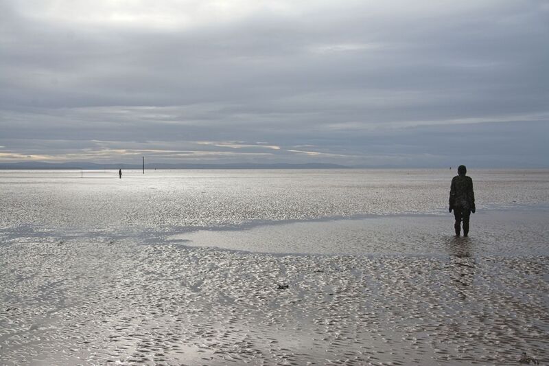 DC 24-0746-060.jpg :: Crosby Beech, Merseyside: Commonly referred to as ‘The Iron Men’ (or even the Crosby Beach statues), the art installation is officially called ‘Another Place’. Another Place was created by world-famous artist and sculptor Sir Antony Gormley, who famously created The Angel of the North. The Iron Men consist of 100 cast iron figures that have been installed along Crosby Beach facing the sea. The figures themselves are modelled from Antony Gormley’s body, and they were cast in the UK in both Halifax and West Bromwich. The Iron Men arrived in Liverpool in July 2005, but their story begins nearly 10 years earlier. In 1997, Another Place was first installed on Cuxhaven beach, in Lower Saxony, Germany. From there, they went to Stavanger in Norway and then to De Panne in Belgium. When The Iron Men found their new home at Crosby Beach in 2005, it was only supposed to be temporary. Photo taken 27/10/2024