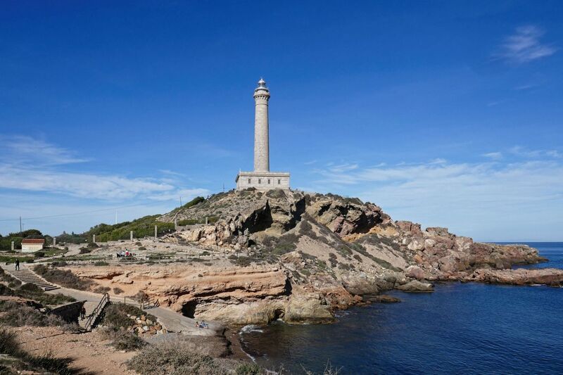DC 24-0764-029.jpg :: Cabo de Palos, La Manga, Spain: The lighthouse of Cabo de Palos is located on an approximately 600 meters-wide small peninsula in the municipality of Cartagena. Back in its time, there was a watchtower where the lighthouse is currently located. The simple structure is defined by its surveillance function as well as the lighthouse-keepers school which was housed in its base. The construction started in 1863 and the lighthouse was first lit on the 31st January, 1865. The building rises 30 meters above sea level, according to Leonardo de Tejada's project. Ashlar stones brought in from a quarry located in the town of Sabinar were used as building material. It has a prism-shaped base of 20 meters on each side and 14 meters high with rusticated edges. In the middle of the base, above an octagonal shaped pedestal rises the 54 meters high tower. It adopts the form of a Tuscan order column, and its capital consists of various corbels that hold up a circular cornice with an openwork parapet in a shape of a balustrade. Above, there is a cylindrical tower where the lantern is built in. Nowadays, it has a beacon with a range of 24 miles. Photo taken 06/12/2024