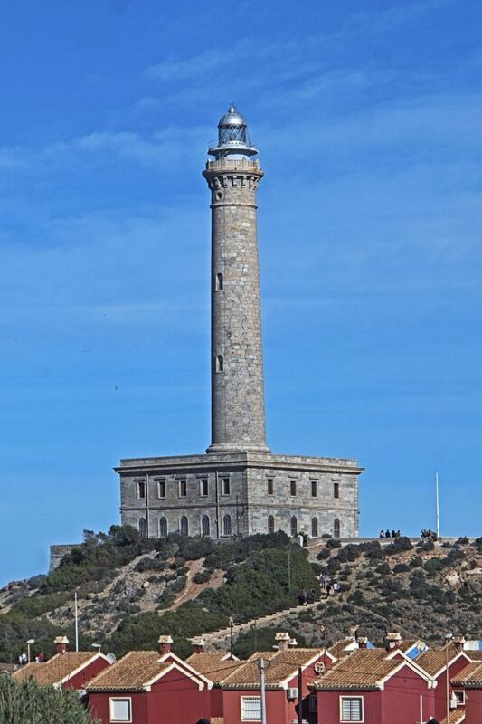 DC 24-0764-034.jpg :: Cabo de Palos, La Manga, Spain: The lighthouse of Cabo de Palos is located on an approximately 600 meters-wide small peninsula in the municipality of Cartagena. Back in its time, there was a watchtower where the lighthouse is currently located. The simple structure is defined by its surveillance function as well as the lighthouse-keepers school which was housed in its base. The construction started in 1863 and the lighthouse was first lit on the 31st January, 1865. The building rises 30 meters above sea level, according to Leonardo de Tejada's project. Ashlar stones brought in from a quarry located in the town of Sabinar were used as building material. It has a prism-shaped base of 20 meters on each side and 14 meters high with rusticated edges. In the middle of the base, above an octagonal shaped pedestal rises the 54 meters high tower. It adopts the form of a Tuscan order column, and its capital consists of various corbels that hold up a circular cornice with an openwork parapet in a shape of a balustrade. Above, there is a cylindrical tower where the lantern is built in. Nowadays, it has a beacon with a range of 24 miles. Photo taken 06/12/2024