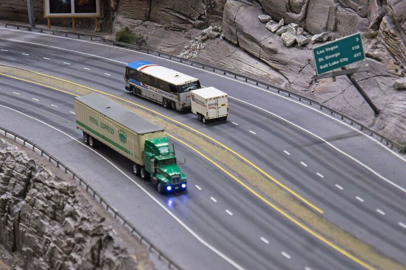 DC 25-0767-052.jpg :: Miniatur Wunderland Hamburg, Germany: The Miniatur Wunderland is, according to Guinness World Records, the largest model railway system in the world. It is located at the historic Speicherstadt in Hamburg and is one of the most popular and most visited sights in Germany. The exhibition includes around 1,230 digitally controlled trains with more than 12,000 wagons. The Wonderland is also designed with around 4,300 houses and bridges, more than 10,000 vehicles – of which around 350 drive independently on the installation – 47 airplanes and around 290,000 figures. The system features a recurring day-night lighting cycle and almost 500,000 built-in LED lights. Of the 7,000 m2 (75,347 sq ft) of floorspace, the models occupy 1,545 m2 (16,630 sq ft). P.s. Part of the USA section of the exhibition. Highway in the west coast of America. Photo taken 20/01/2025