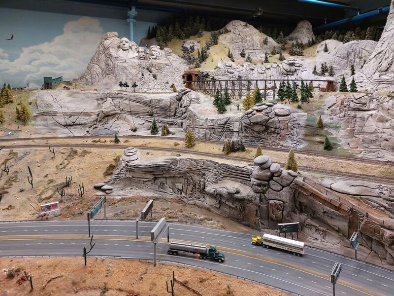 DC 25-0767-057.jpg :: Miniatur Wunderland Hamburg, Germany: The Miniatur Wunderland is, according to Guinness World Records, the largest model railway system in the world. It is located at the historic Speicherstadt in Hamburg and is one of the most popular and most visited sights in Germany. The exhibition includes around 1,230 digitally controlled trains with more than 12,000 wagons. The Wonderland is also designed with around 4,300 houses and bridges, more than 10,000 vehicles – of which around 350 drive independently on the installation – 47 airplanes and around 290,000 figures. The system features a recurring day-night lighting cycle and almost 500,000 built-in LED lights. Of the 7,000 m2 (75,347 sq ft) of floorspace, the models occupy 1,545 m2 (16,630 sq ft). P.s. Part of the USA section of the exhibition. Highway in the west coast of America. Photo taken 20/01/2025