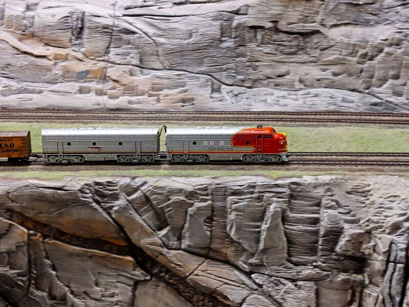DC 25-0767-058.jpg :: Miniatur Wunderland Hamburg, Germany: The Miniatur Wunderland is, according to Guinness World Records, the largest model railway system in the world. It is located at the historic Speicherstadt in Hamburg and is one of the most popular and most visited sights in Germany. The exhibition includes around 1,230 digitally controlled trains with more than 12,000 wagons. The Wonderland is also designed with around 4,300 houses and bridges, more than 10,000 vehicles – of which around 350 drive independently on the installation – 47 airplanes and around 290,000 figures. The system features a recurring day-night lighting cycle and almost 500,000 built-in LED lights. Of the 7,000 m2 (75,347 sq ft) of floorspace, the models occupy 1,545 m2 (16,630 sq ft). P.s. Part of the USA section of the exhibition. Railway in the west coast of America. Locomotive Santa Fe. Photo taken 20/01/2025