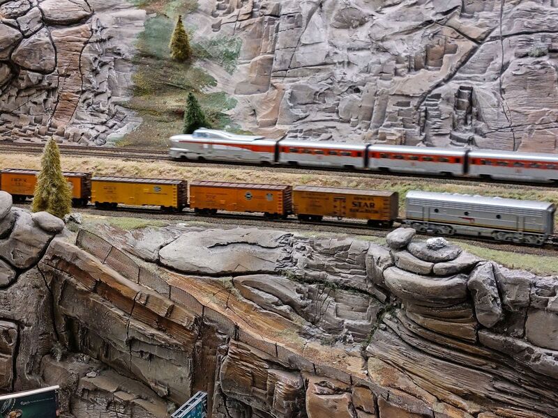 DC 25-0767-059.jpg :: Miniatur Wunderland Hamburg, Germany: The Miniatur Wunderland is, according to Guinness World Records, the largest model railway system in the world. It is located at the historic Speicherstadt in Hamburg and is one of the most popular and most visited sights in Germany. The exhibition includes around 1,230 digitally controlled trains with more than 12,000 wagons. The Wonderland is also designed with around 4,300 houses and bridges, more than 10,000 vehicles – of which around 350 drive independently on the installation – 47 airplanes and around 290,000 figures. The system features a recurring day-night lighting cycle and almost 500,000 built-in LED lights. Of the 7,000 m2 (75,347 sq ft) of floorspace, the models occupies 1,545 m2 (16,630 sq ft). P.s. Part of the USA section of the exhibition. Railway in the west coast of America. Photo taken 20/01/2025