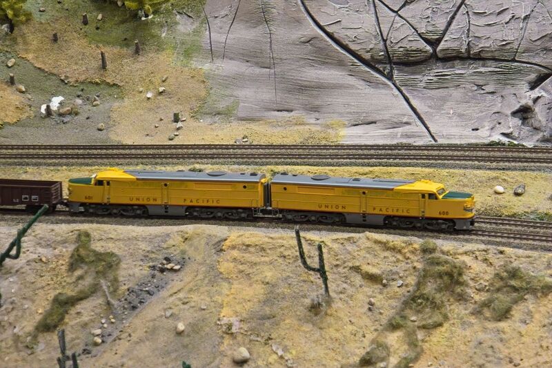 DC 25-0767-066.jpg :: Miniatur Wunderland Hamburg, Germany: The Miniatur Wunderland is, according to Guinness World Records, the largest model railway system in the world. It is located at the historic Speicherstadt in Hamburg and is one of the most popular and most visited sights in Germany. The exhibition includes around 1,230 digitally controlled trains with more than 12,000 wagons. The Wonderland is also designed with around 4,300 houses and bridges, more than 10,000 vehicles – of which around 350 drive independently on the installation – 47 airplanes and around 290,000 figures. The system features a recurring day-night lighting cycle and almost 500,000 built-in LED lights. Of the 7,000 m2 (75,347 sq ft) of floorspace, the models occupies 1,545 m2 (16,630 sq ft). P.s. Part of the USA section of the exhibition. Railway in the west coast of America. Photo taken 20/01/2025