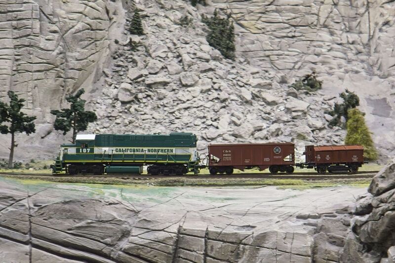 DC 25-0767-068.jpg :: Miniatur Wunderland Hamburg, Germany: The Miniatur Wunderland is, according to Guinness World Records, the largest model railway system in the world. It is located at the historic Speicherstadt in Hamburg and is one of the most popular and most visited sights in Germany. The exhibition includes around 1,230 digitally controlled trains with more than 12,000 wagons. The Wonderland is also designed with around 4,300 houses and bridges, more than 10,000 vehicles – of which around 350 drive independently on the installation – 47 airplanes and around 290,000 figures. The system features a recurring day-night lighting cycle and almost 500,000 built-in LED lights. Of the 7,000 m2 (75,347 sq ft) of floorspace, the models occupies 1,545 m2 (16,630 sq ft). P.s. Part of the USA section of the exhibition. Railway in the west coast of America. California Northern Railroad Train Locomotive 107 Woodland CA. Photo taken 20/01/2025