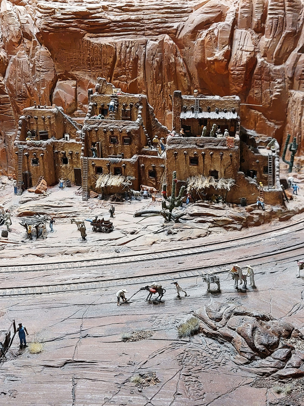 DC 25-0767-082.jpg :: Miniatur Wunderland Hamburg, Germany: The Miniatur Wunderland is, according to Guinness World Records, the largest model railway system in the world. It is located at the historic Speicherstadt in Hamburg and is one of the most popular and most visited sights in Germany. The exhibition includes around 1,230 digitally controlled trains with more than 12,000 wagons. The Wonderland is also designed with around 4,300 houses and bridges, more than 10,000 vehicles – of which around 350 drive independently on the installation – 47 airplanes and around 290,000 figures. The system features a recurring day-night lighting cycle and almost 500,000 built-in LED lights. Of the 7,000 m2 (75,347 sq ft) of floorspace, the models occupy 1,545 m2 (16,630 sq ft). P.s. Part of the USA section of the exhibition. A Pueblo Settlement in Arizona. Showing the people their traditional clay huts, some of which are only accessible by ladders. Photo taken 20/01/2025