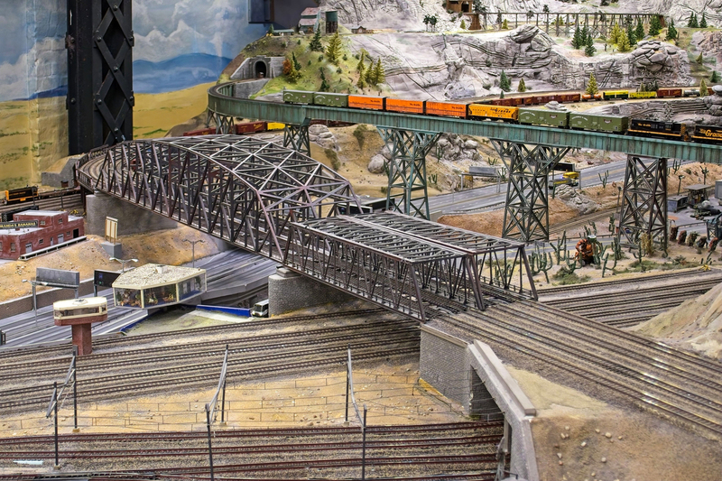 DC 25-0767-092.jpg :: Miniatur Wunderland Hamburg, Germany: The Miniatur Wunderland is, according to Guinness World Records, the largest model railway system in the world. It is located at the historic Speicherstadt in Hamburg and is one of the most popular and most visited sights in Germany. The exhibition includes around 1,230 digitally controlled trains with more than 12,000 wagons. The Wonderland is also designed with around 4,300 houses and bridges, more than 10,000 vehicles – of which around 350 drive independently on the installation – 47 airplanes and around 290,000 figures. The system features a recurring day-night lighting cycle and almost 500,000 built-in LED lights. Of the 7,000 m2 (75,347 sq ft) of floorspace, the models occupy 1,545 m2 (16,630 sq ft). P.s. Part of the USA section of the exhibition. Photo taken 20/01/2025