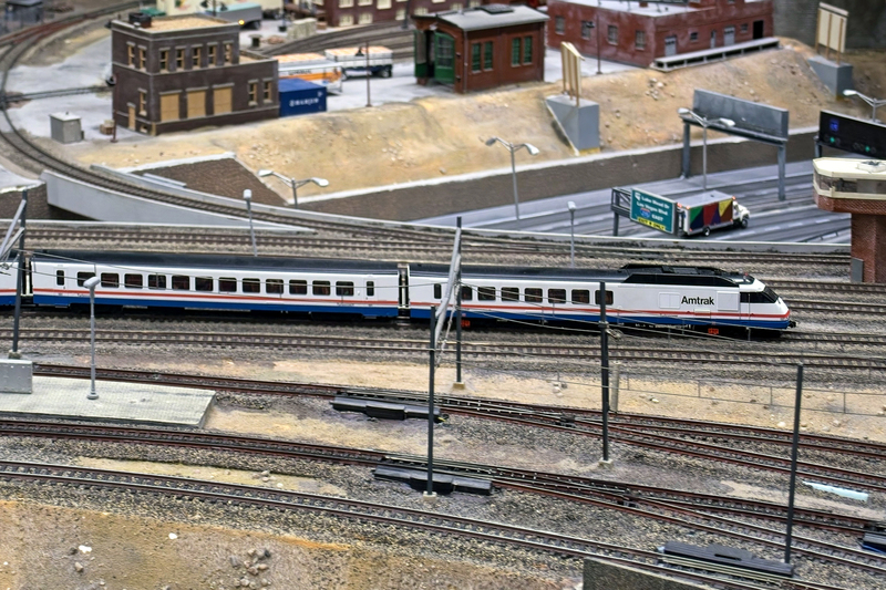 DC 25-0767-104.jpg :: Miniatur Wunderland Hamburg, Germany: The Miniatur Wunderland is, according to Guinness World Records, the largest model railway system in the world. It is located at the historic Speicherstadt in Hamburg and is one of the most popular and most visited sights in Germany. The exhibition includes around 1,230 digitally controlled trains with more than 12,000 wagons. The Wonderland is also designed with around 4,300 houses and bridges, more than 10,000 vehicles – of which around 350 drive independently on the installation – 47 airplanes and around 290,000 figures. The system features a recurring day-night lighting cycle and almost 500,000 built-in LED lights. Of the 7,000 m2 (75,347 sq ft) of floorspace, the models occupy 1,545 m2 (16,630 sq ft). P.s. Part of the USA section of the exhibition. Rapido-amtrak-turbo-03. Photo taken 20/01/2025