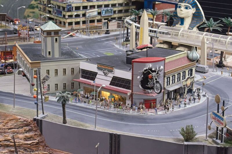 DC 25-0767-116.jpg :: Miniatur Wunderland Hamburg, Germany: The Miniatur Wunderland is, according to Guinness World Records, the largest model railway system in the world. It is located at the historic Speicherstadt in Hamburg and is one of the most popular and most visited sights in Germany. The exhibition includes around 1,230 digitally controlled trains with more than 12,000 wagons. The Wonderland is also designed with around 4,300 houses and bridges, more than 10,000 vehicles – of which around 350 drive independently on the installation – 47 airplanes and around 290,000 figures. The system features a recurring day-night lighting cycle and almost 500,000 built-in LED lights. Of the 7,000 m2 (75,347 sq ft) of floorspace, the models occupy 1,545 m2 (16,630 sq ft). P.s. Part of the USA section of the exhibition. Las Vegas, Harley Davidson Cafe. Photo taken 20/01/2025
