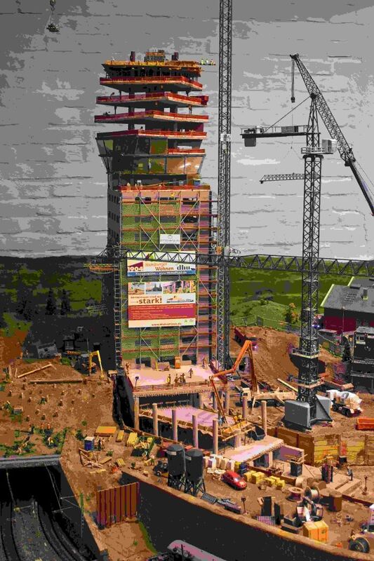 DC 25-0767-166.jpg :: Miniatur Wunderland Hamburg, Germany: The Miniatur Wunderland is, according to Guinness World Records, the largest model railway system in the world. It is located at the historic Speicherstadt in Hamburg and is one of the most popular and most visited sights in Germany. The exhibition includes around 1,230 digitally controlled trains with more than 12,000 wagons. The Wonderland is also designed with around 4,300 houses and bridges, more than 10,000 vehicles – of which around 350 drive independently on the installation – 47 airplanes and around 290,000 figures. The system features a recurring day-night lighting cycle and almost 500,000 built-in LED lights. Of the 7,000 m2 (75,347 sq ft) of floorspace, the models occupy 1,545 m2 (16,630 sq ft). P.s. Part of the Germany section of the exhibition. P.s. High-rise construction site in the Hamburg section. Photo taken 20/01/2025.