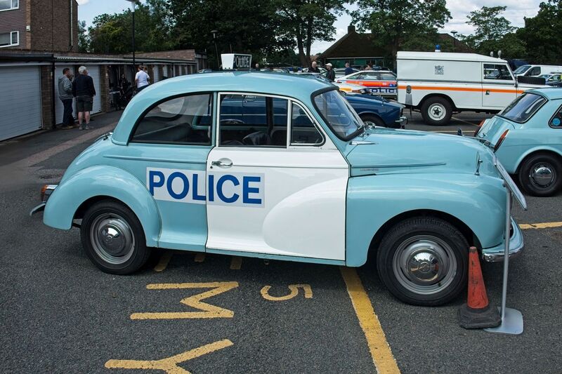 DC 25-0777-013.jpg :: Marlow House, Sidcup, Historic Police Cars Display: A Met Police 1970 Morris Minor 1000 Panda Car. Part of the Metropolitan Police Historic Vehicle Collection. This vehicle was used as a supervisor’s car to check on the beat officers and respond to calls. The aerial on the offside rear wing is an indicator that it wasn't an ordinary beat car. The white stripe across the roof that linked both doors is now missing on the later versions of Met Police Pandas, in order to reduce cost. Photo taken 08-06-2025
