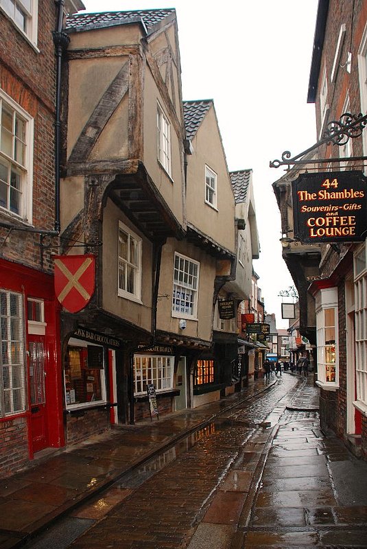 DC 12-0277-008.jpg :: Shambles, York: The Shambles (official name Shambles) is an old street in York, England, with overhanging timber-framed buildings, some dating back as far as the fourteenth century. It was once known as The Great Flesh Shambles, probably from the Anglo-Saxon Fleshammels (literally 'flesh-shelves'), the word for the shelves that butchers used to display their meat. As recently as 1872 there were twenty-five butchers' shops in the street but now there are none. 24/01/2012
