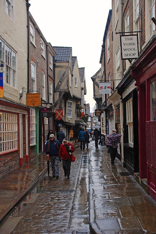 DC 12-0277-011.jpg :: Shambles, York: The Shambles (official name Shambles) is an old street in York, England, with overhanging timber-framed buildings, some dating back as far as the fourteenth century. It was once known as The Great Flesh Shambles, probably from the Anglo-Saxon Fleshammels (literally 'flesh-shelves'), the word for the shelves that butchers used to display their meat. As recently as 1872 there were twenty-five butchers' shops in the street but now there are none. 24/01/2012
