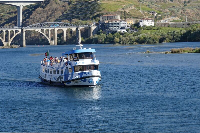 DC 22-0789-002.jpg :: Saga Douro River Cruise, Regua Lamego to Pinhao, River Douro: The MS Infanta of Barcadouro cruises, a passenger ship sailing under the flag of Portugal. Cruising on the River Douro at Peso da Regua. The Bridges Régua Railway Bridge at Peso da Régua, also known as the Régua Road Bridge and Ponte Miguel Torga in the background. Photo taken 30/08/2022.