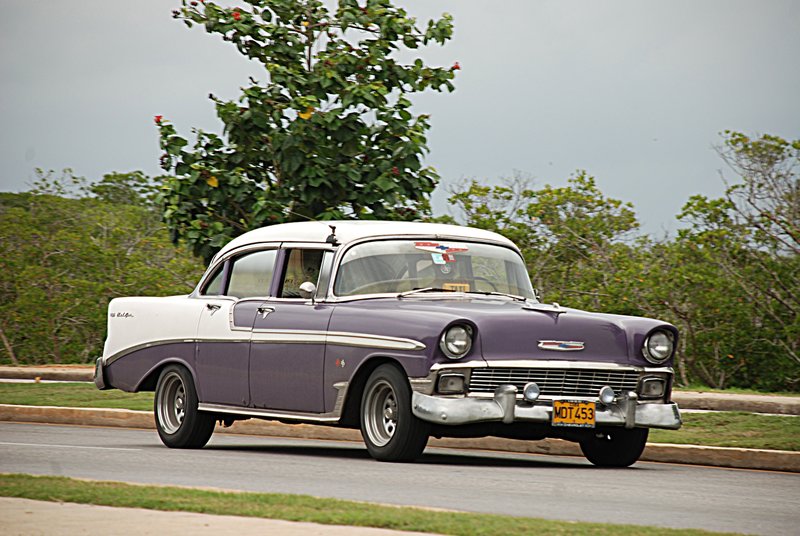 DC 11-0240-002.jpg :: 2011 - Cuban Classic Cars - 1956 Chevrolet Bel Air Sedan driving along the main road through Varadero. These American dream cars are common all over Cuba. There is no suggestion that the car is in its original condition as these cars are kept running using all sorts or suitable spares and non original components. The chances are the engines are either Japanese or Russian. Reg. No. MOT 453 on a yellow Cuban plate. 03/06/2011  
