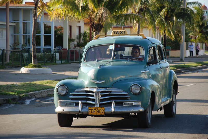 DC 11-0240-003.jpg :: 2011 - Cuban Classic Cars - 1948 Chevrolet Fleetline Sportmaster Sedan driving in Cienfuegos. These American dream cars are common all over Cuba. There is no suggestion that the car is in its original condition as these cars are kept running using all sorts or suitable spares and non original components. The chances are the engines are either Japanese or Russian. Reg. No. FDF 902 on a yellow cuban plate. 01/06/2011  
