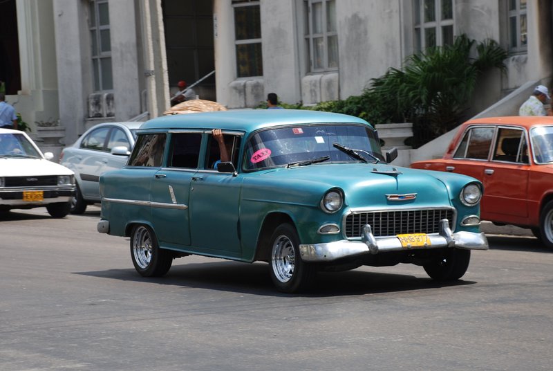 DC 11-0240-004.jpg :: 2011 - Cuban Classic Cars - 1955 Chevrolet Styleline 210 Wagon driving outside the Hotel Tryp Habana Libre in Havana. These American dream cars are common all over Cuba. There is no suggestion that the car is in its original condition as these cars are kept running using all sorts or suitable spares and non original components. The chances are the engines are either Japanese or Russian. Reg. No. HHB 977 on a yellow Cuban plate. 26/05/2011  
