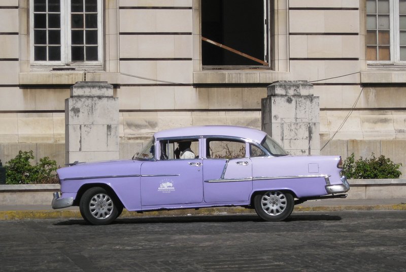 DC 11-0240-019.jpg :: 2011 - Cuban Classic Cars - 1955 Chevrolet Styleline 210 four door sedan driving in Havana. These American dream cars are common all over Cuba. There is no suggestion that the car is in its original condition as these cars are kept running using all sorts or suitable spares and non original components. The chances are the engines are either Japanese or Russian. Reg. No. HSH 562 on a blue Cuban plate. 26/05/2011  
