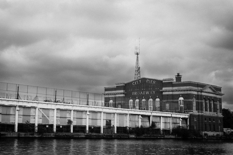 Baltimore City Pier (DLM_20140802_035_0029_web).jpg :: In a revitalized area of the city called Fells Point there are dozens of quaint little shops, restaurants and bars.  The cobble stone streets, the Bond Street Wharf and the Pirate Ship coexist, yet the city dock sits untouched and decaying.