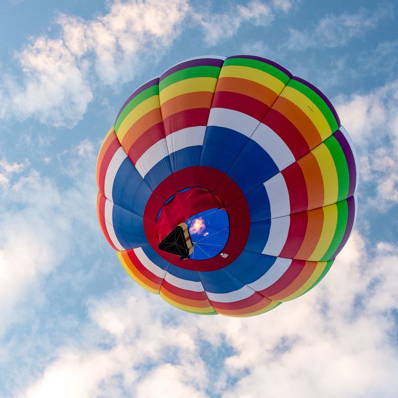 Rainbows-Fire-and Air OH MY (DLM_20160805_041_0467_web).jpg :: Two of the 4 elements: Fire and Air work together to lift this colorful balloon during the Great Chesapeake Balloon and Wine Festival at Triple Creek Winery in Cordova, MD