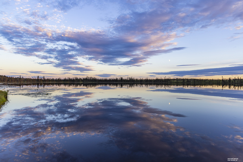 Fort Nelson Sunset.jpg :: It was a beautiful way to end an awesome day's drive along the Al-Can highway.
Where I came across this lake South of Fort Nelson British Columbia.
The clouds mirroring off the still water, the magnificent colors of the sky, and the contrast of the trees along the far shoreline was something to behold.