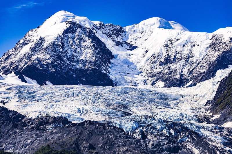 Harriman Fjord Mountain Peak.jpg :: One of the many Glacier Peaks rising up out of the Harriman Fjord in the Prince William Sound.
The diversity of terrain with the receded edge of the glacier exposing the earth that has been grinded away by the constantly moving glacier,  the deep crevices of blue ice being exposed at the glaciers edge, the rememanents of many avalanches in it's valleys, the deep hanging snow packs close to the ridges of the jagged mountain that just seem to be waiting for the moment to explode down the face, and finally the smooth white wind groomed peak reaching into deep blue sky.  I have never been a mountain climber but as I reflect on my way up this mountain I understand the fascination of the human spirit to stand at the top and breathe in the sense of awe.