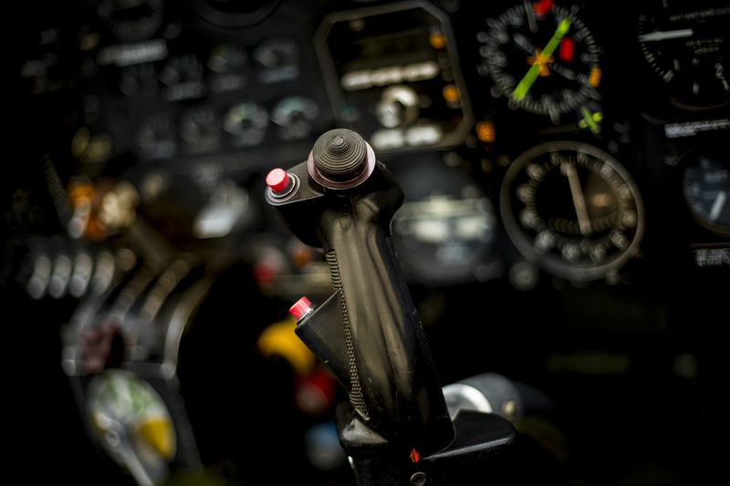 2018-06-23 Air Combat USA 027.jpg :: Cockpit of Marchetti SIAI SF260 fighter with joystick in focus and instuments diffused in background