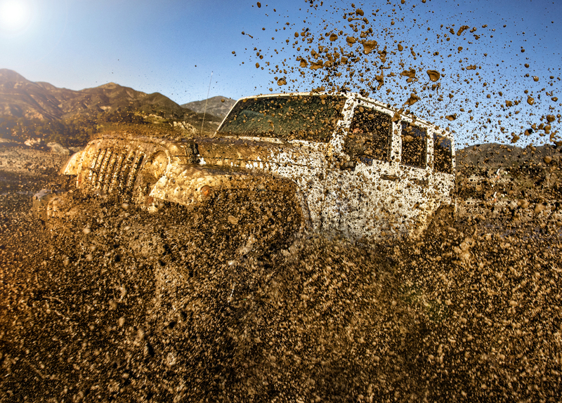 A 4x4 Vehivle plowing through mud Trabucco Canyon CA.jpg :: Jeep 4x4 driving through puddle with mud exploding off of the vehicle in Trabucco Canyon California