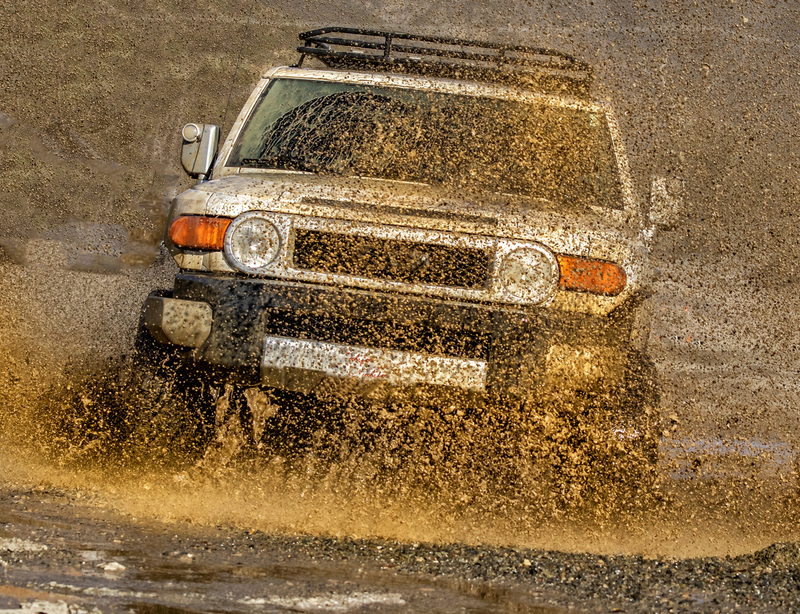 A 4x4 vehicle driving through puddle with water splashing Trabucco Canyon CA.jpg :: A 4x4 vehicle  driving through puddle with water splashing Trabucco Canyon Ca