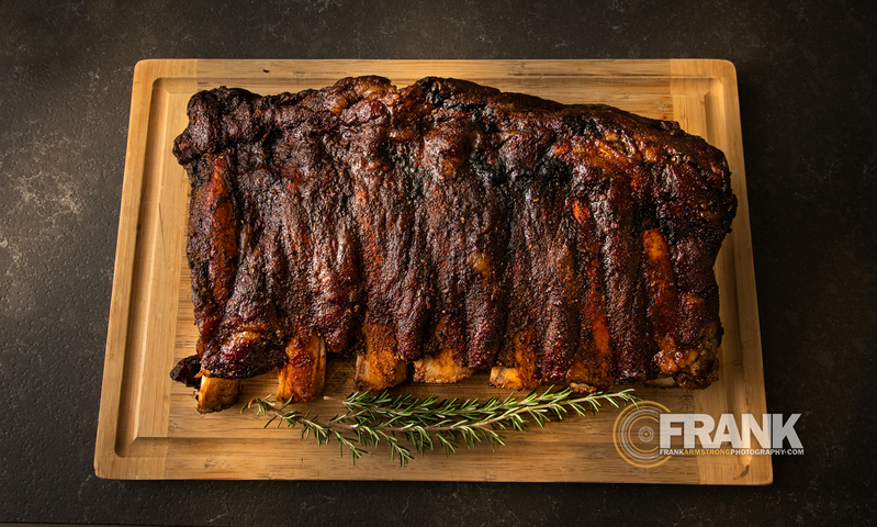 Cooked Beef Ribs on a cutting board with rosemary 001LOGO(1).jpg