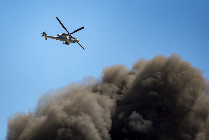Helicopter flies over large smoke cloud from exploded munitions 001A.jpg :: Helicopter flies over large smoke cloud from exploded munitions