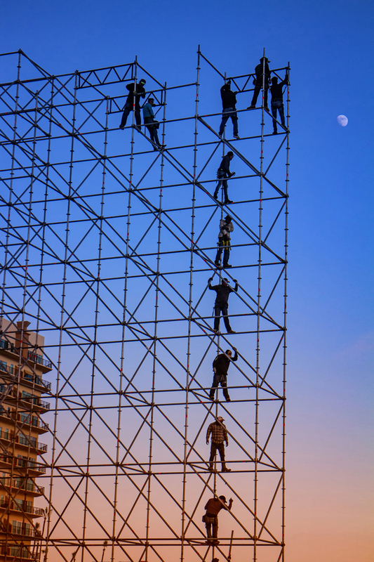 Men standing on concert scaffolding at sunset with moon in Rosarito Mexico-1 .jpg