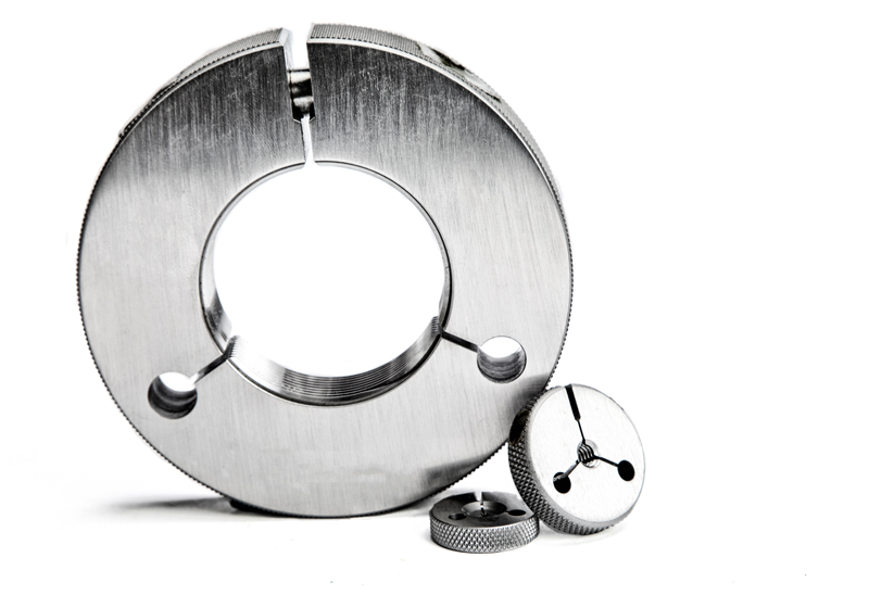Metal Gauge Cylinders 001.jpg :: Three metal gauges of different sizes on a white background