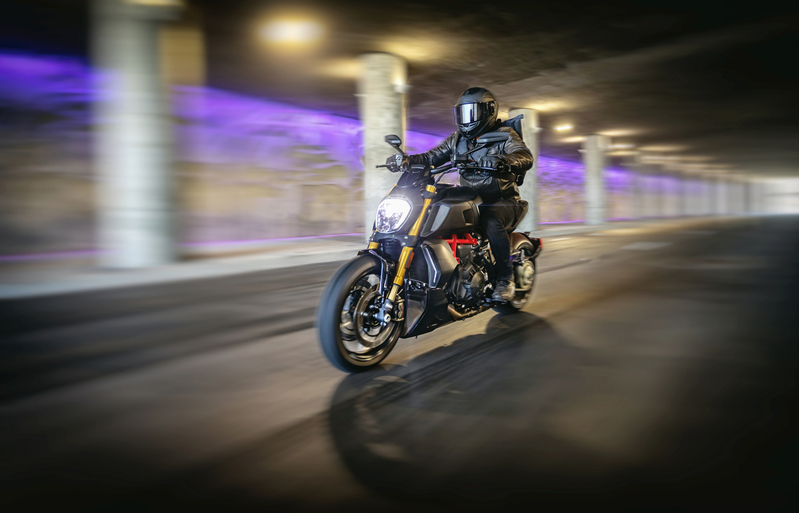 Motorcyclist in full leathers riding through tunnel with purple lights-001a.jpg