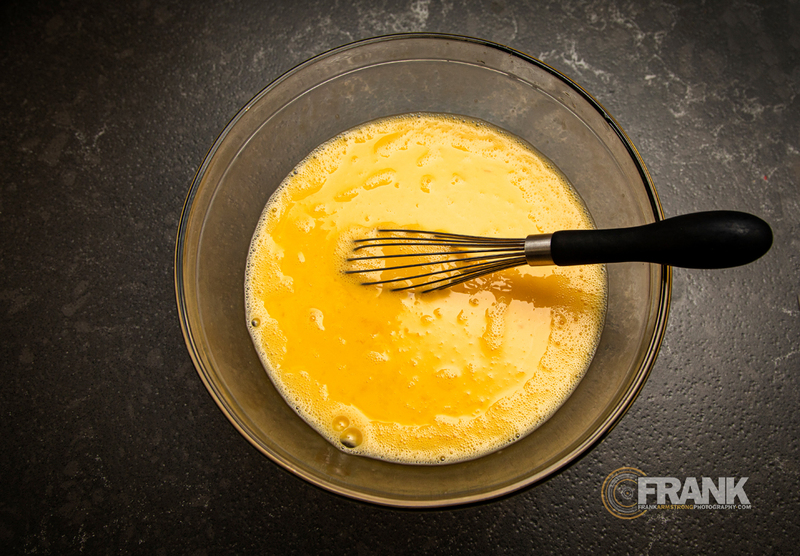 Overhead image of whisked eggs in a glass bowl 004-LOGO .jpg :: Overhead image of whisked eggs in a glass bowl