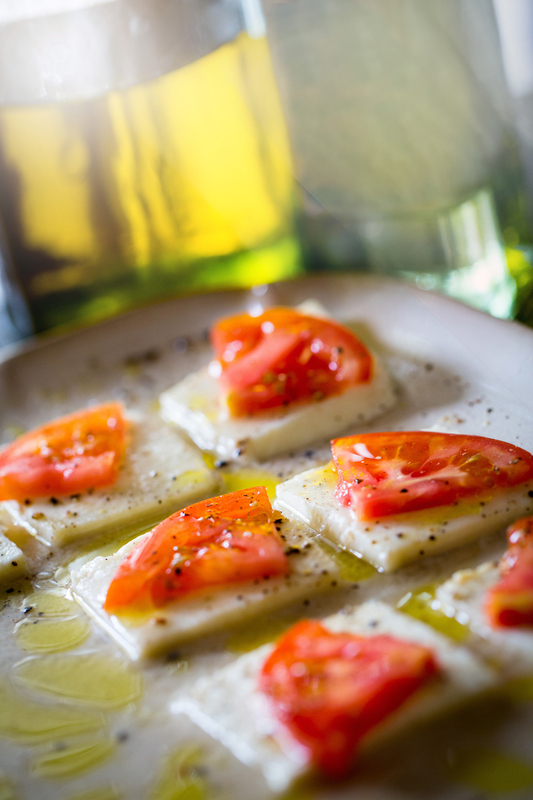 Tomato Slices on Squares of Buffalo Mozzarella Cheeze drizzled in Oil in Sunlight.jpg :: Tomato Slices on Squares of Buffalo Mozzarella Cheese drizzled in Oil in Sunlight