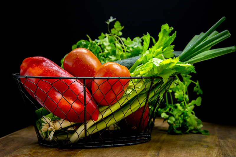 Vegetables in wire basket on wood table Horizontal.jpg