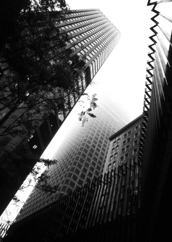 BW - View from Metro.jpg :: Coming out of a subway station (Chicago, San Francisco - lost track!) to this above ground scene. I liked the framing of the wrought iron fence and the mood provided by the fog. Seems like the buildings go up forever.
