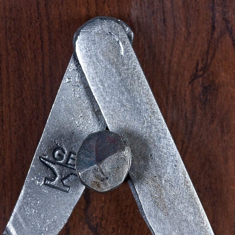 Compass Detail - RTP.jpg :: Close-up detail of the mason's dividers. Each piece of the divider is hand-forged and the hinge joint is hand-forged and fully functional. Glen's blacksmith mark is seen on the right leg of the divider.