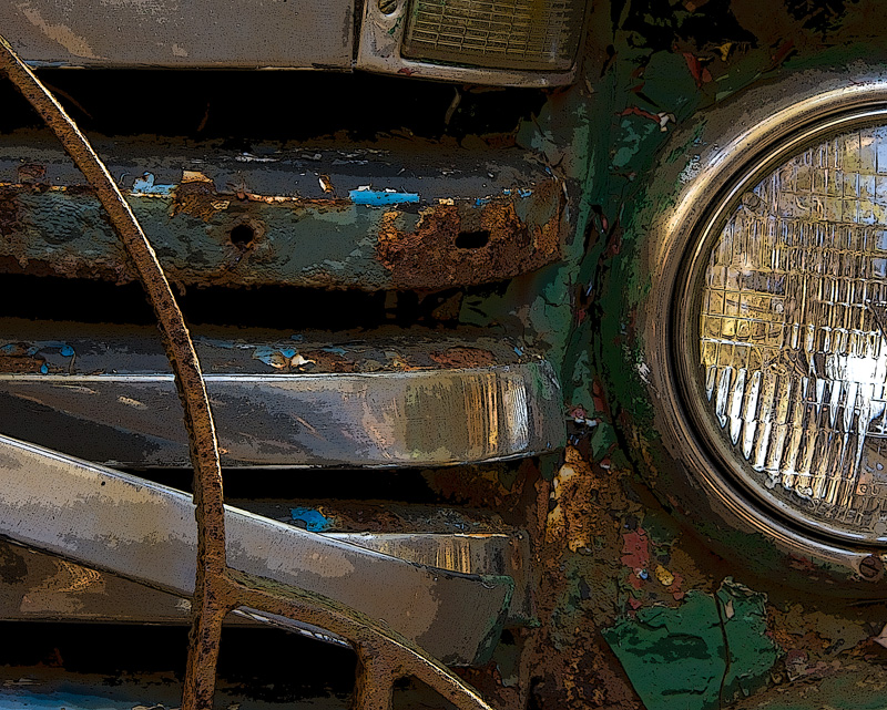 Ford Grill Abstract-3.jpg :: The curved line of the grill guard attracted me to this shot. I also like the added element of the glass mixing with the metal. Amazing that the headlight is intact and the metal components are bent and battered.