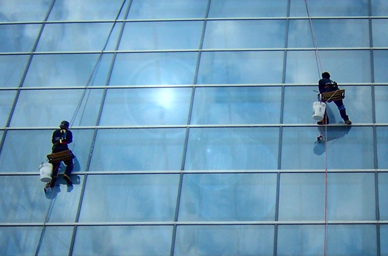 Window Washers - Va Beach.jpg :: Took this shot at a convention center (maybe Richmond, VA). The empty space between the two washers makes a very dramatic backdrop for text.