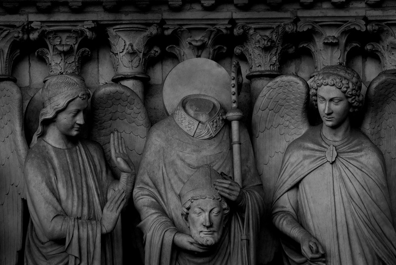 NotreDameFront.jpg :: Statue of Beheaded St. Denis on Entrance to Notre Dame Cathedral