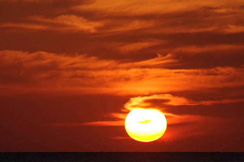 Huge-sun-with-whispy-clouds-Negril.jpg :: Whispy clouds create an interesting sunset at Negril Beach, Jamaica
